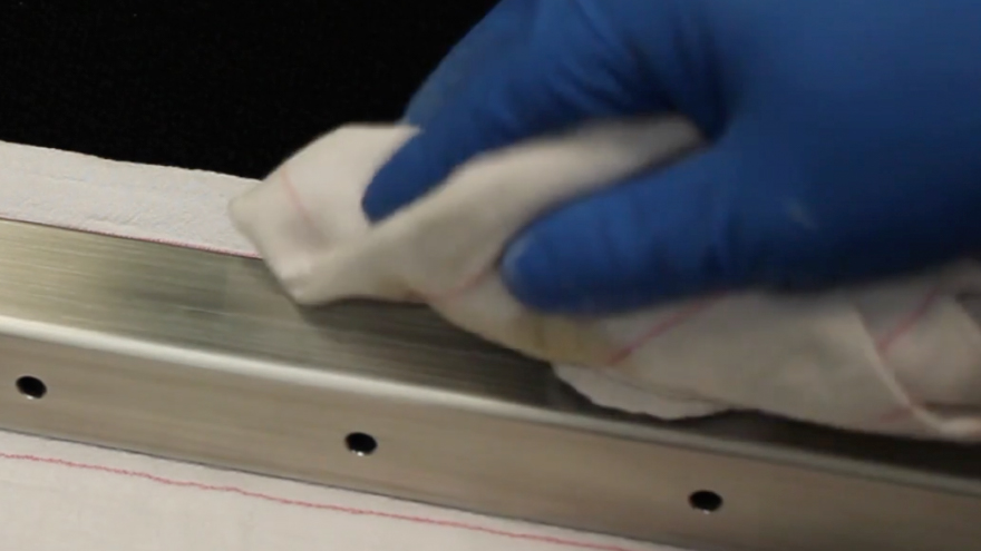 Apply stainless steel cleaner to railing in the direction of the finish