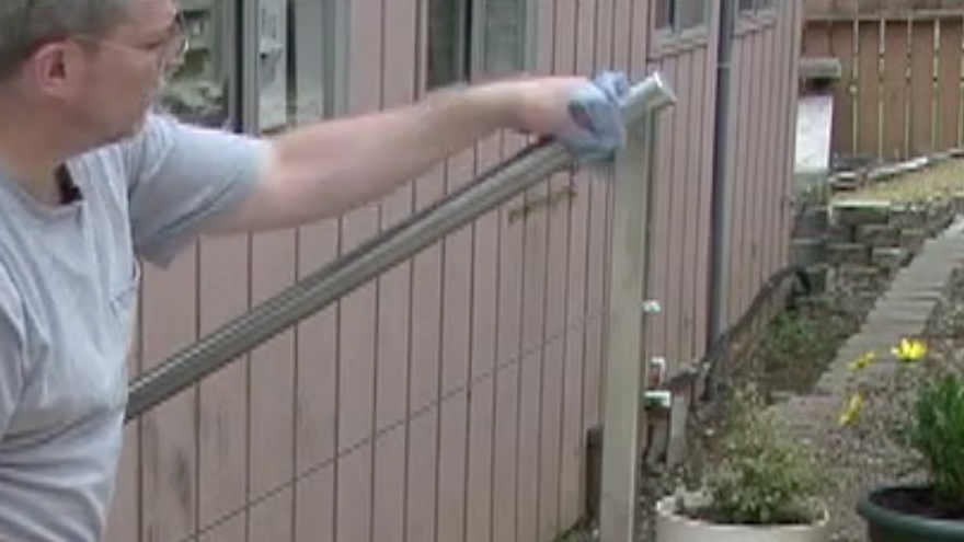 Wipe excess bonding agent from stainless steel railing components
