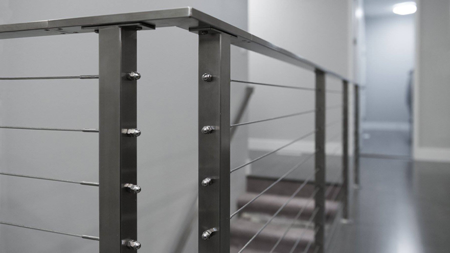 Flat handrail on stair cable rail made from stainesss steel.