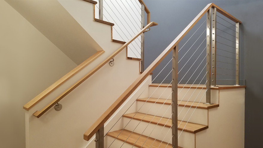Flat wood handrail on stair cable rail.