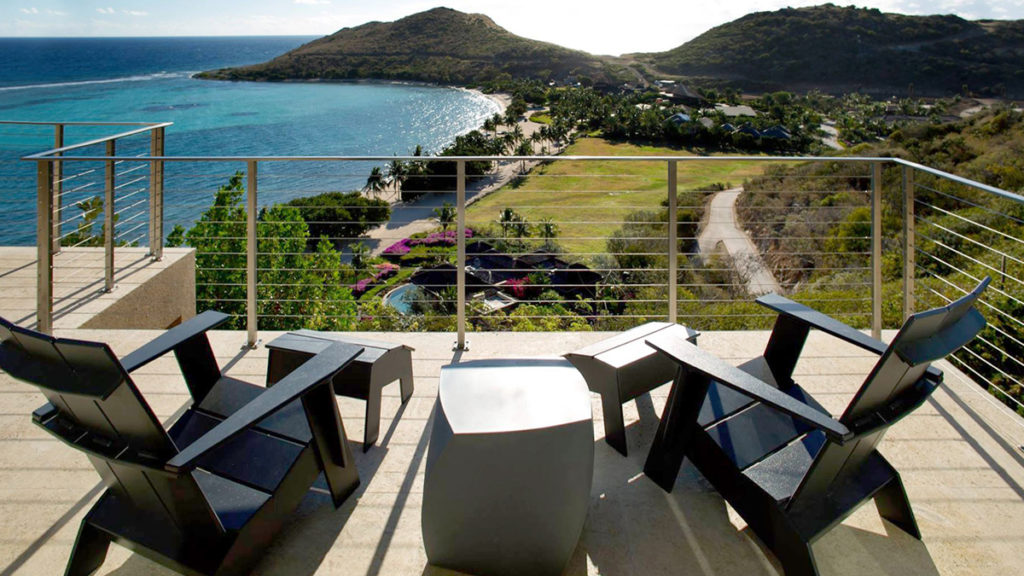 Deck chairs overlooking a coastline, with Rainier Cable Railing in place.