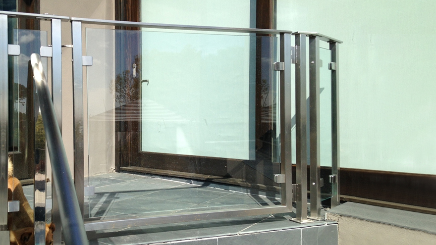 Glass panel railing system with an elegant glass gate