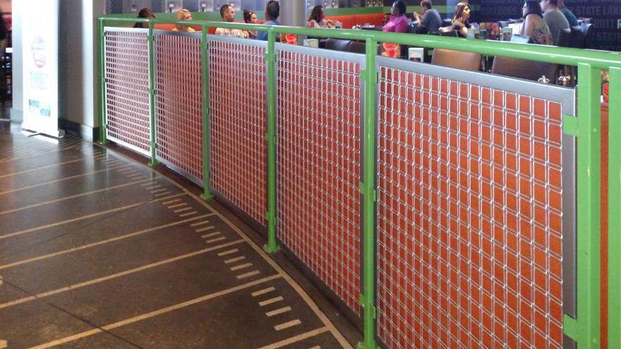 Unique mesh panel powder coated railing system installed in a commercial setting