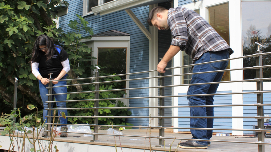 Brandon Schmahl and Sue Ellen installing an AGS railing system