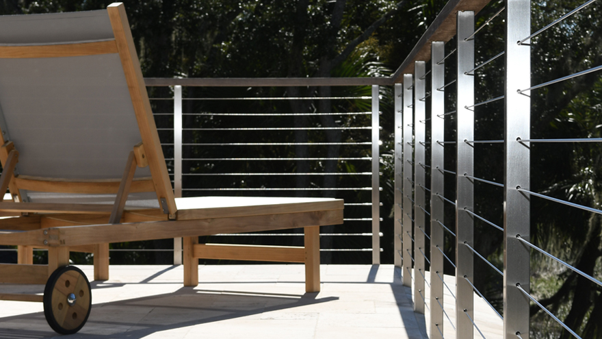Close-up of cable handrail with wire railing threaded through railing posts.