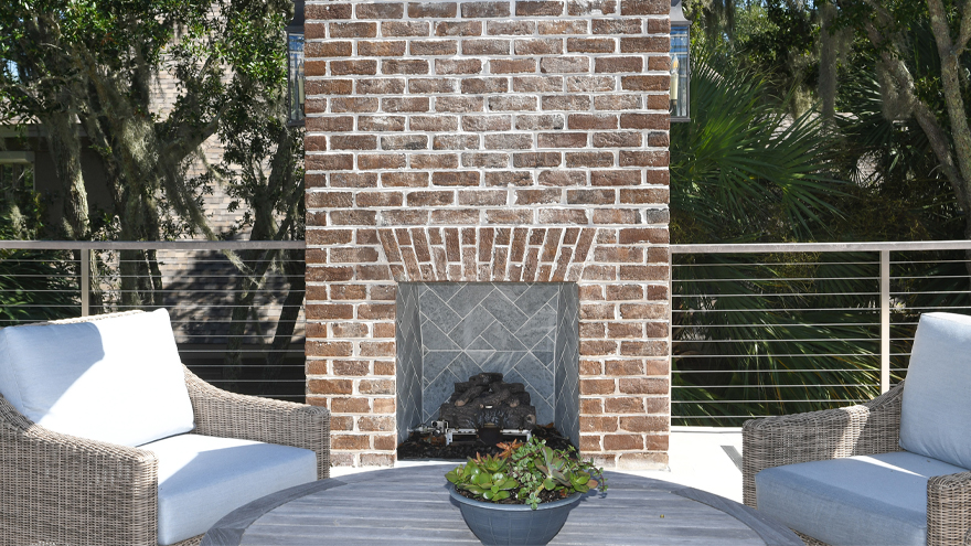 Cable porch railing and exterior fireplace for a luxury custom home.