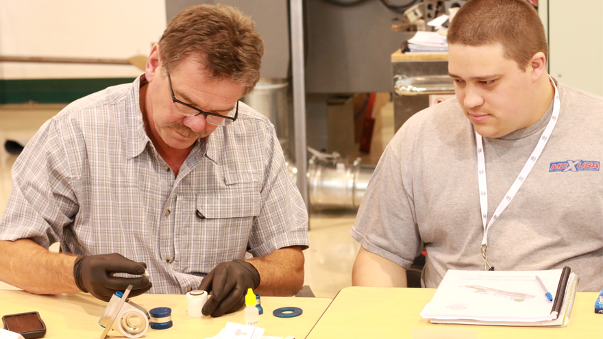 Ryan Giffin from AGS Stainless learns how to use a laser cutting machine during a training session.