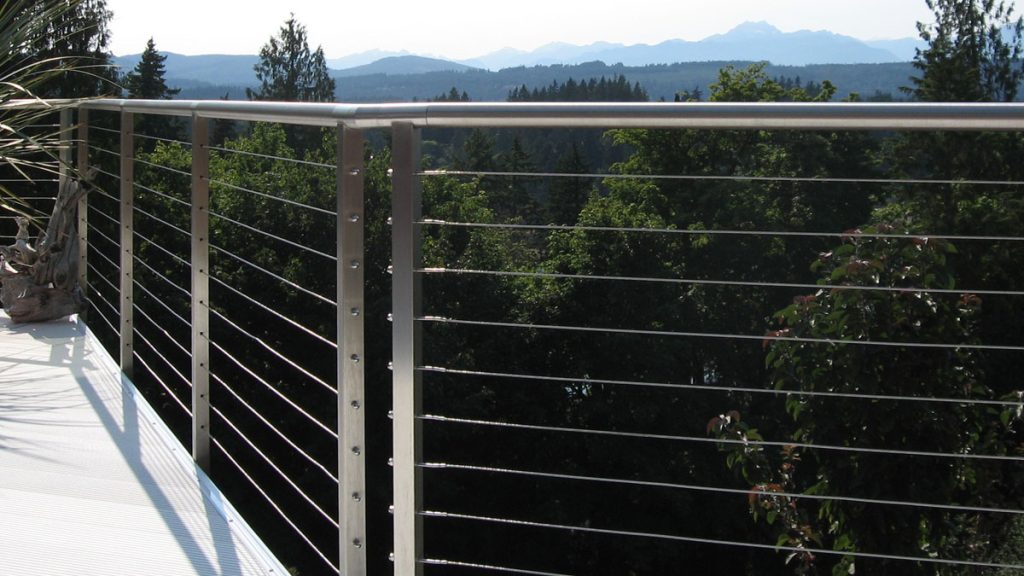 AGS Stainless, Inc. Rainier brushed stainless steel cable railing system with a round handrail, residential deck installation.